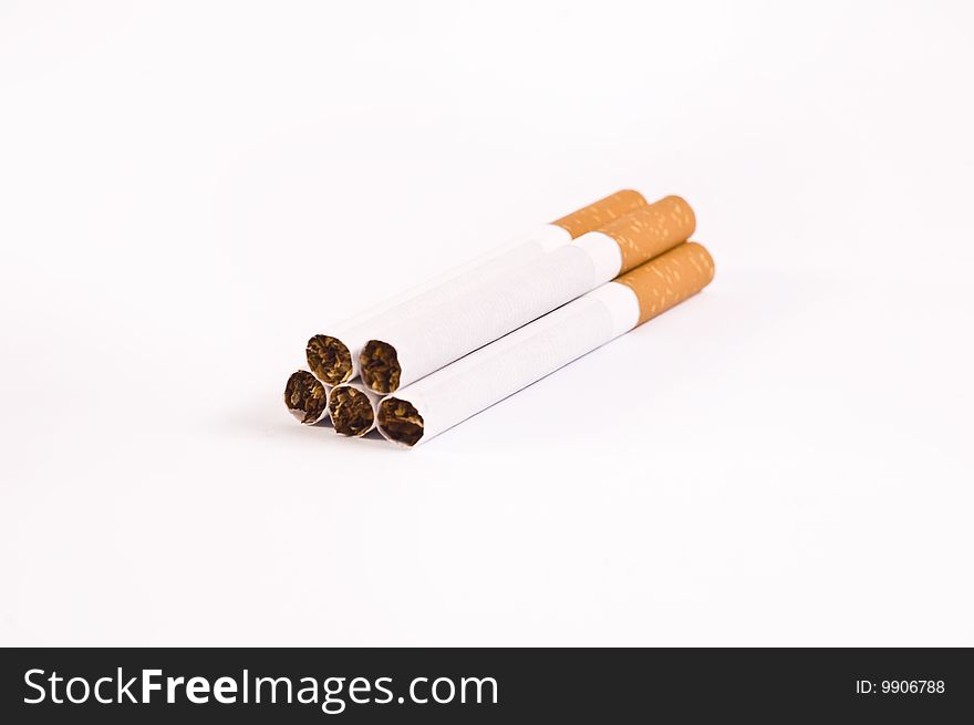 Five cigarettes isolated on bright background