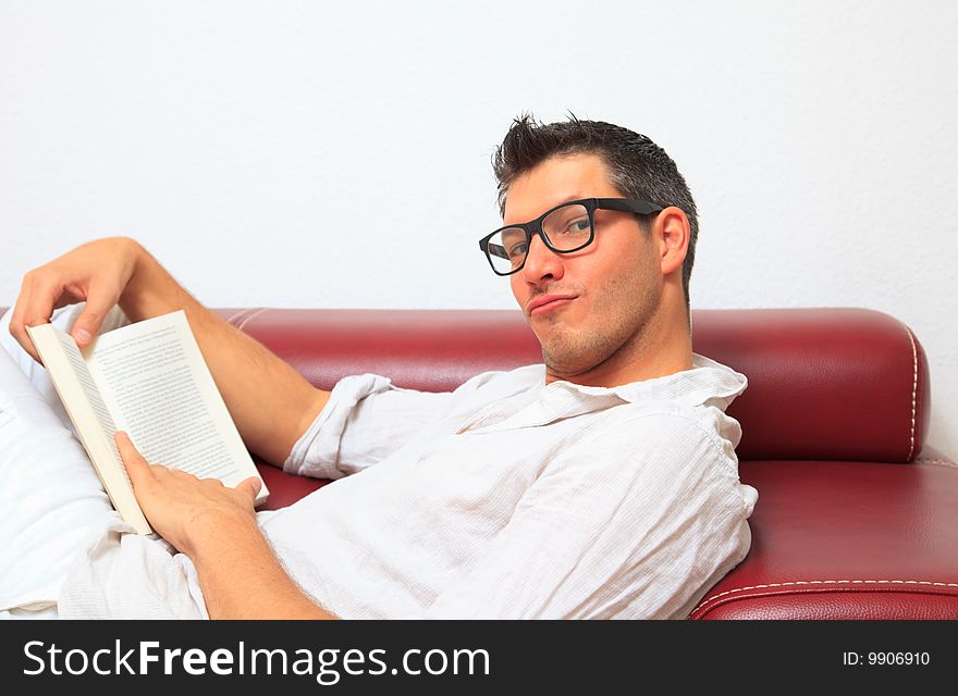Man enjoining freeteim with book at home. Man enjoining freeteim with book at home