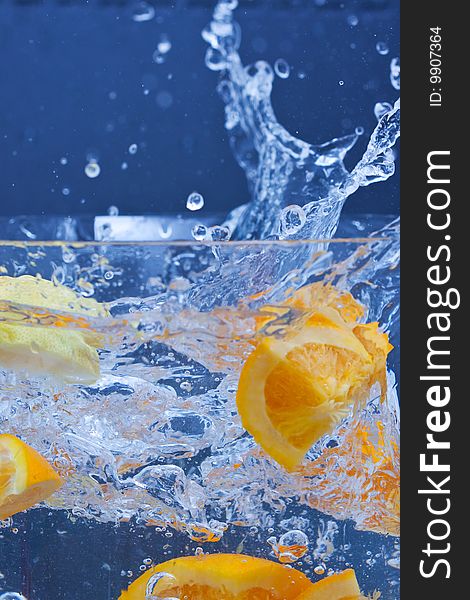 Lemon and orange splashing on fresh water. Lemon and orange splashing on fresh water