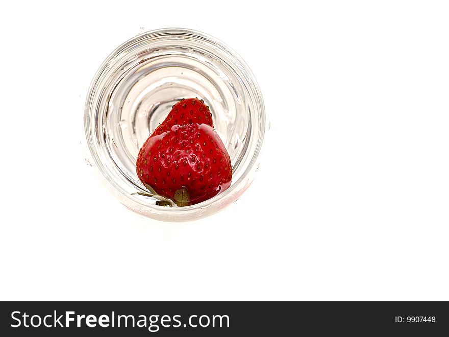 One strawberry on the glass isolated on white background