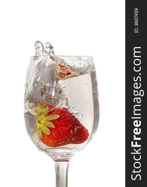 Strawberry in the clear water on white background in the glass. Strawberry in the clear water on white background in the glass