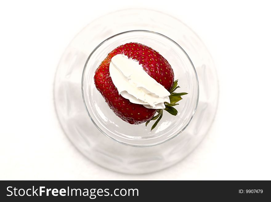 Red fresh strawberry on the whipped-cream in the glass on white. Red fresh strawberry on the whipped-cream in the glass on white