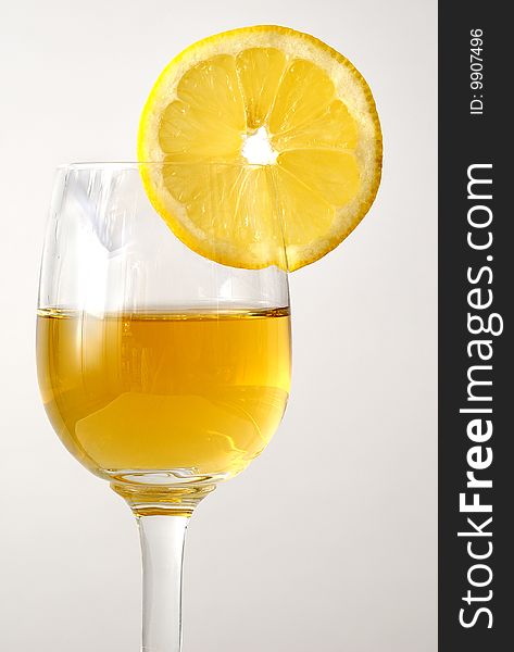 The drink in the glass with a fresh orange. The drink in the glass with a fresh orange