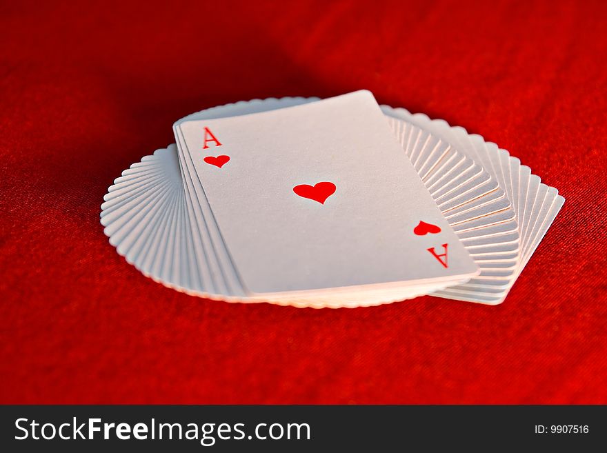 The pack of the playing cards which have been spread out by a fan. The pack of the playing cards which have been spread out by a fan