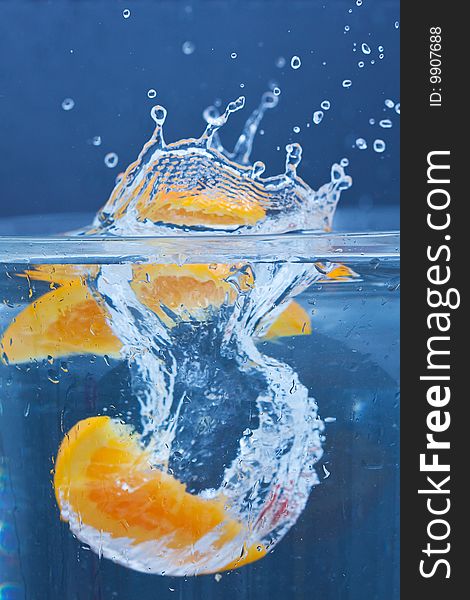 Lemon and orange splashing on fresh water. Lemon and orange splashing on fresh water