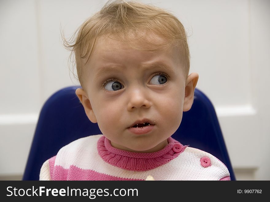 Portrait of baby looking to someone beside with big wondering eyes. Portrait of baby looking to someone beside with big wondering eyes