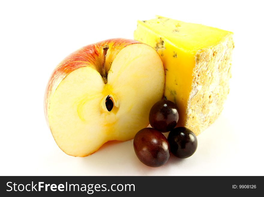 Sliced red apple with slice of blue cheese and grapes with clipping path on a white background. Sliced red apple with slice of blue cheese and grapes with clipping path on a white background