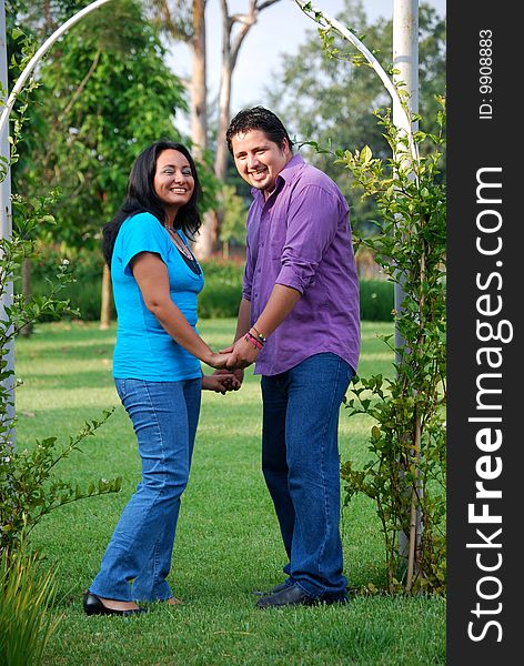 Beautiful Hispanic couple embracing in an outdoor setting. Beautiful Hispanic couple embracing in an outdoor setting