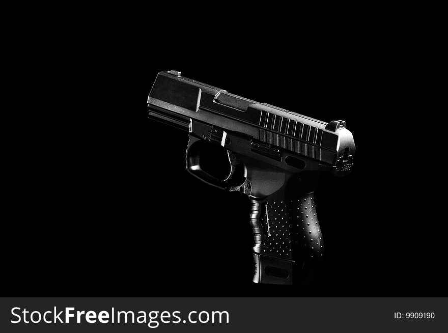 The black gun isolated on black background
