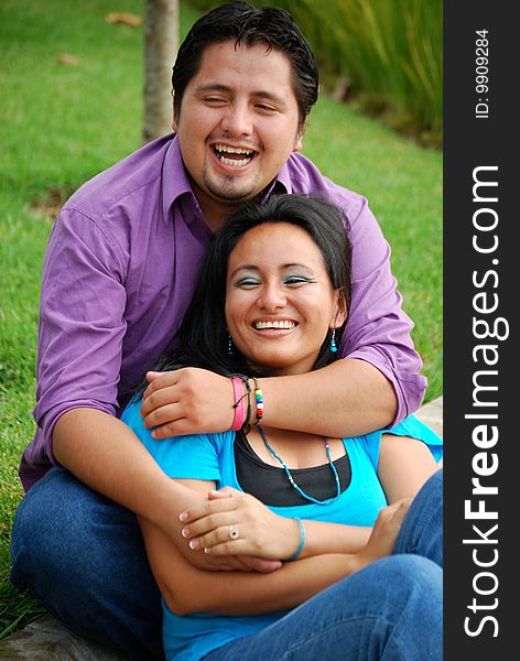 Beautiful Hispanic couple embracing in an outdoor setting. Beautiful Hispanic couple embracing in an outdoor setting