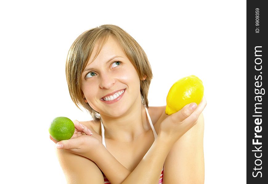 Portrait of a cute young Caucasian blond lady with a nice colorful striped summer dress who is smiling and she is holding a fresh lemon and a lime in her crossed hands. Isolated on white. Portrait of a cute young Caucasian blond lady with a nice colorful striped summer dress who is smiling and she is holding a fresh lemon and a lime in her crossed hands. Isolated on white.