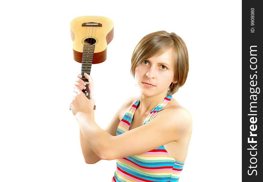 Portrait of a cute Caucasian blond girl with a nice colorful striped summer dress who is angry and she want to fight with an ukulele (small Hawaiian guitar). Isolated on white. Portrait of a cute Caucasian blond girl with a nice colorful striped summer dress who is angry and she want to fight with an ukulele (small Hawaiian guitar). Isolated on white.