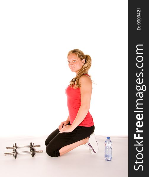 Young beautiful woman in the gym over white background