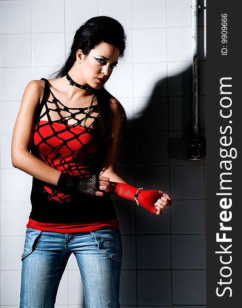 Punk Girl posing hard on an underground background high contrast. Punk Girl posing hard on an underground background high contrast