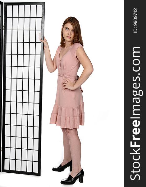 Pretty teen in black shoes and pink dress next to screen. Pretty teen in black shoes and pink dress next to screen