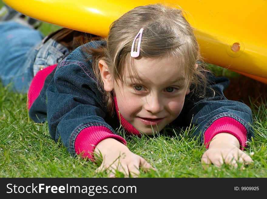 Young girl lies on the grass