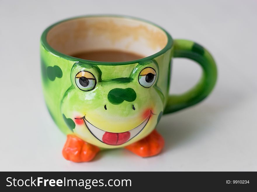 Funny frog-like cup with coffee in it