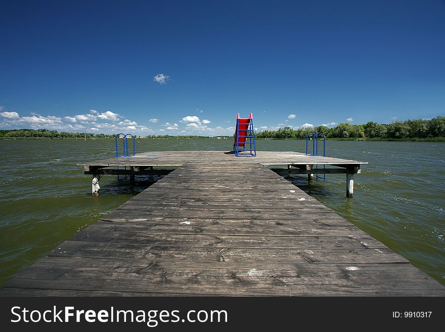 Pier with the slide on the lake