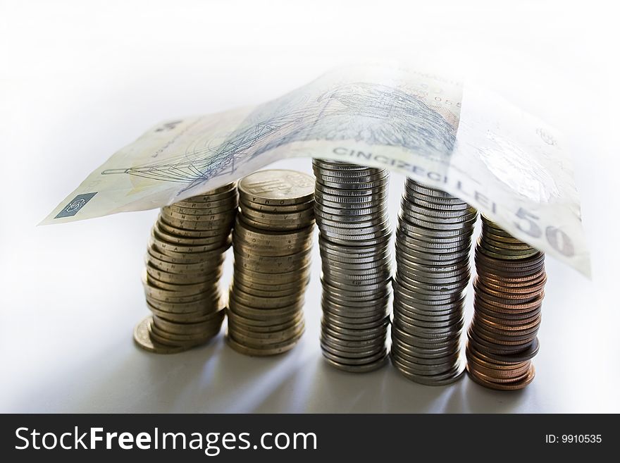 Pillar of coins with roof of banknotes. Pillar of coins with roof of banknotes