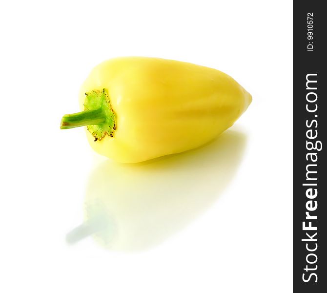 An isolated single pepper with reflection