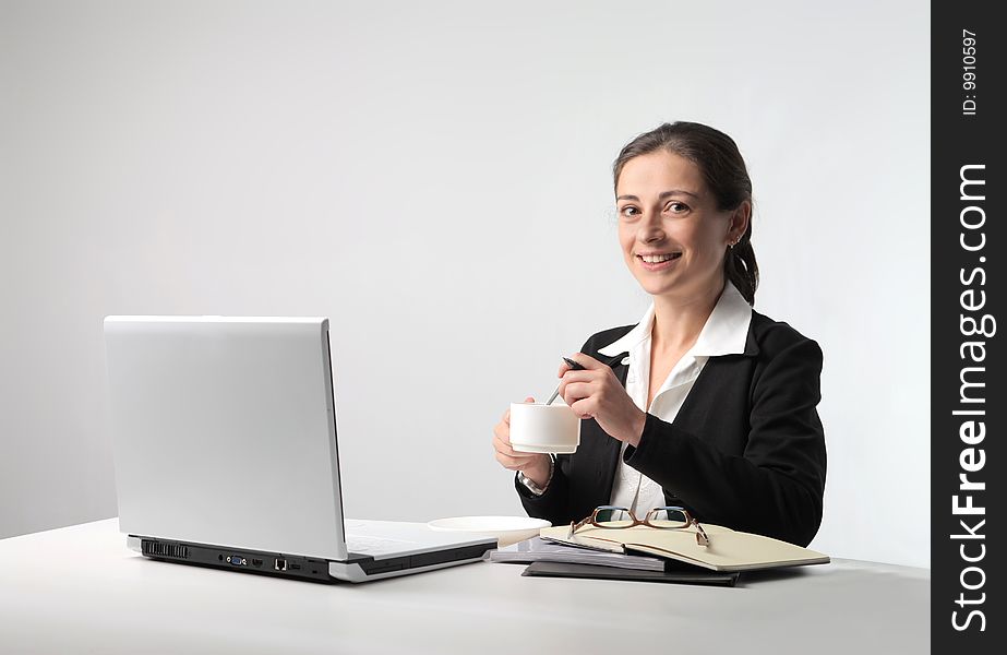 Business woman with cup of coffee and laptop. Business woman with cup of coffee and laptop