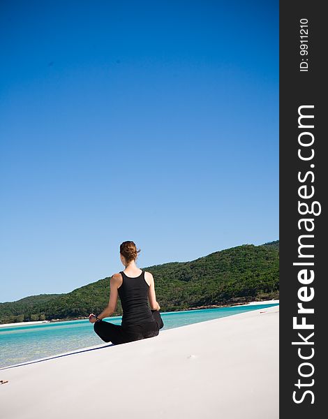 Woman Meditating On Beach