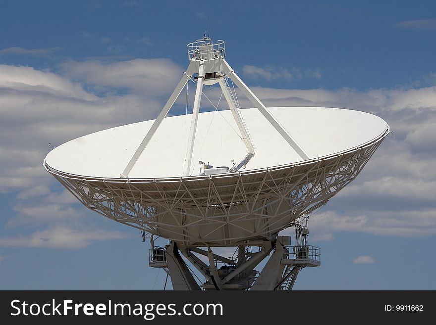 Dish of radio telescope against clouded blue sky. Dish of radio telescope against clouded blue sky.