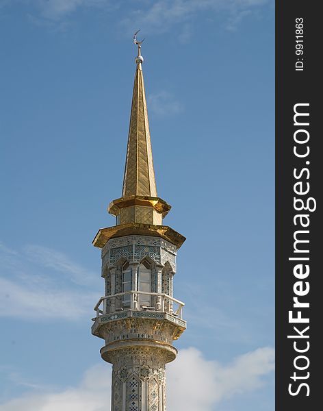 The dome of minaret overpeers on blue sky. The dome of minaret overpeers on blue sky