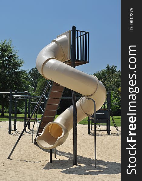 A large plastic slide at a children's park. A large plastic slide at a children's park.
