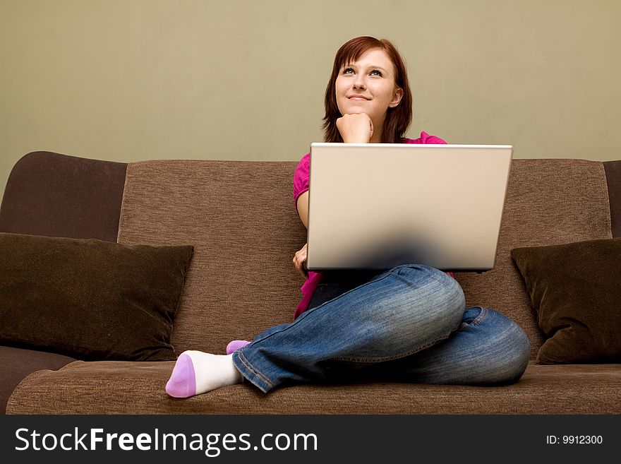 Woman with laptop on sofa