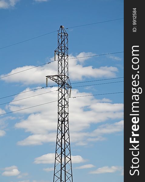 High-voltage post on a background blue sky