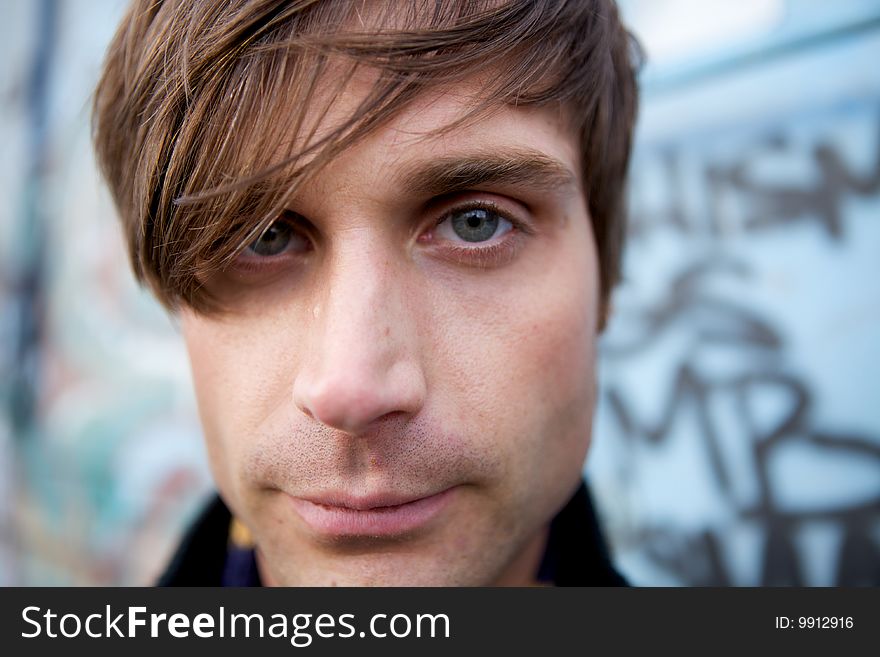 A Close-Up of a young attractive artist type with a scarf and cool haircut