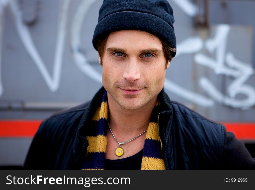 A beautiful young man with a cap and a scarf