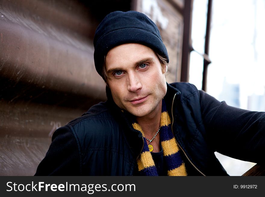 A beautiful young man with a cap and a scarf