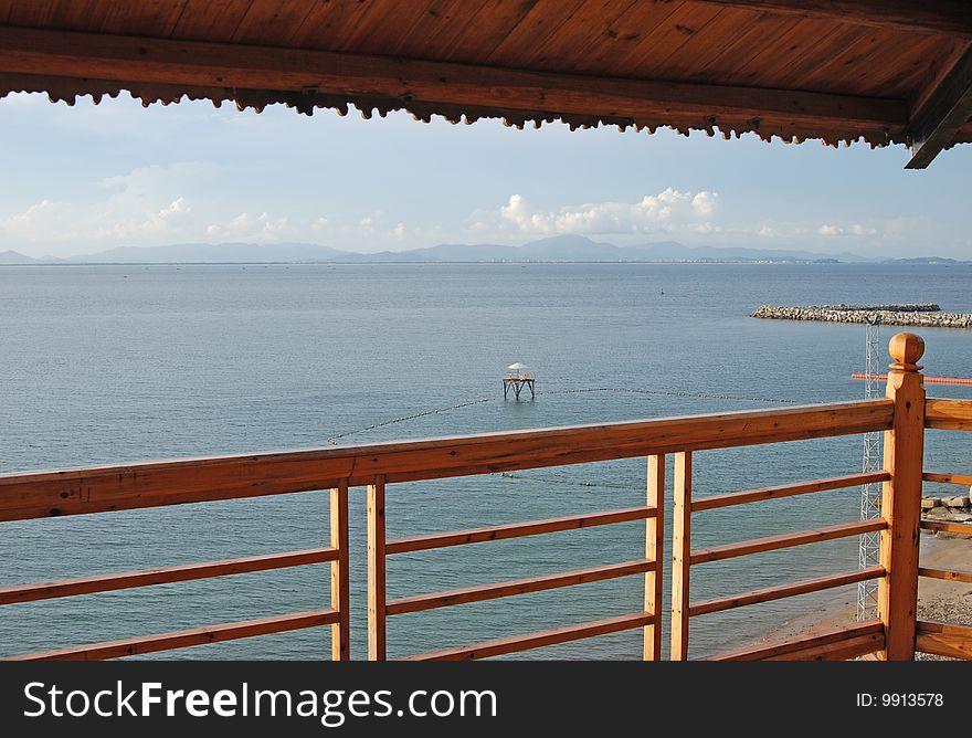 Overlooking the seaside beach from a wooden house.