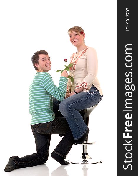 Two casual dressed teenagers , teenage men holding rose flower and woman in love. studio shot. Two casual dressed teenagers , teenage men holding rose flower and woman in love. studio shot.