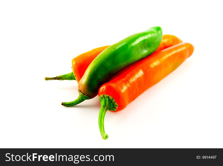 One green and two red chillis with clipping path on a white background. One green and two red chillis with clipping path on a white background