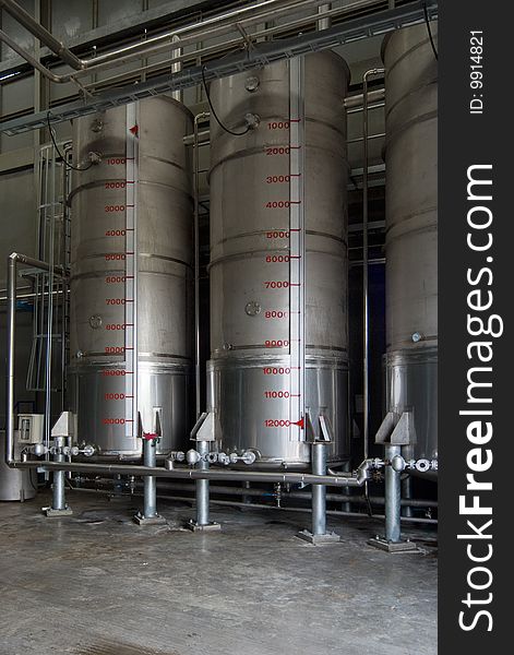 Industrial storage tanks for liquids at processing plant.