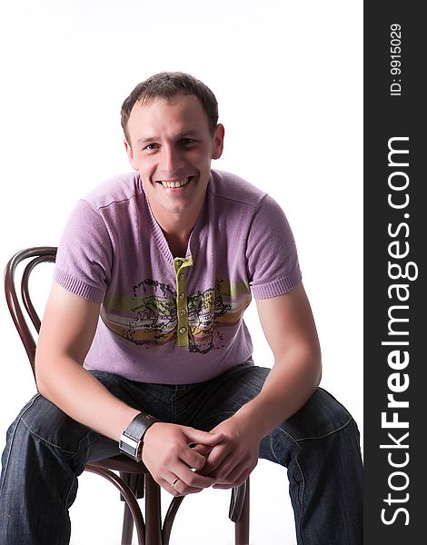 Young man sitting on a bent-wood chair