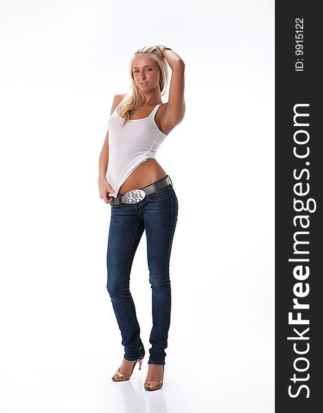 Young blonde woman in white shirt and blue jeans