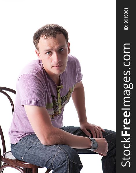 Young man sitting on a bent-wood chair
