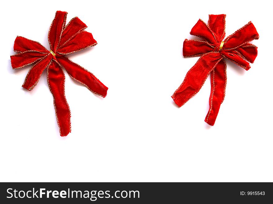 Two velvet christmas bows next to each other isolated on a white background