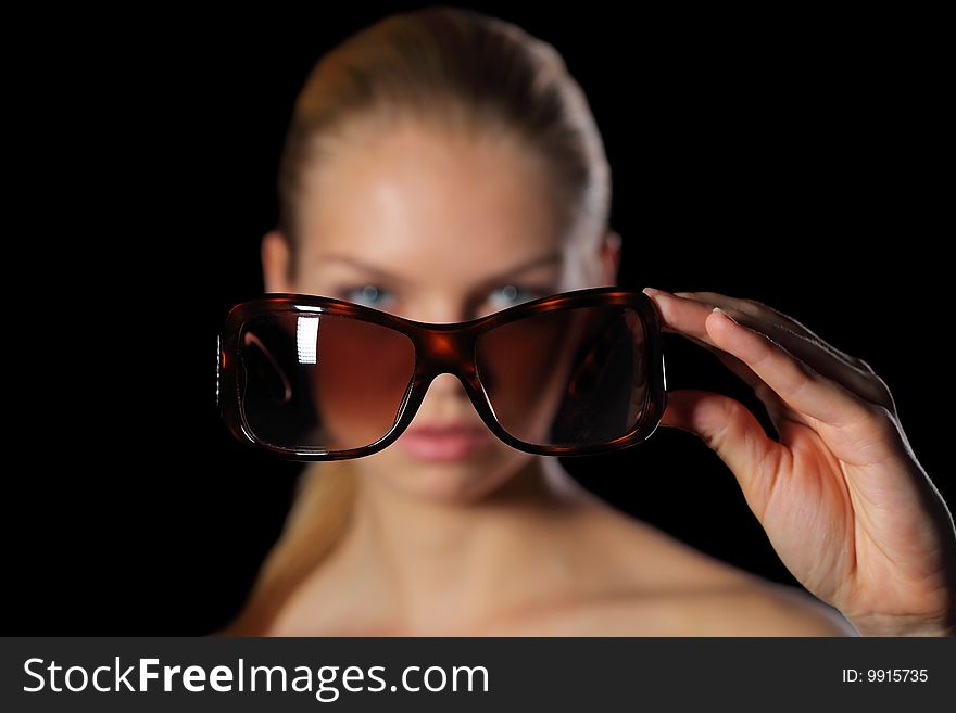 Young woman holding sun glasses. Young woman holding sun glasses