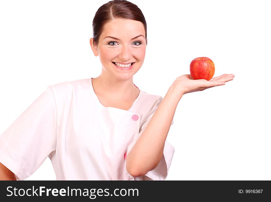 A nurse/dietican holding up an apple and smiling. A nurse/dietican holding up an apple and smiling.