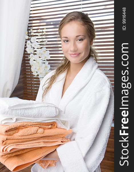 The beautiful girl has towels in hands
