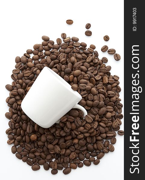 White cup of coffee beans isolated on white background