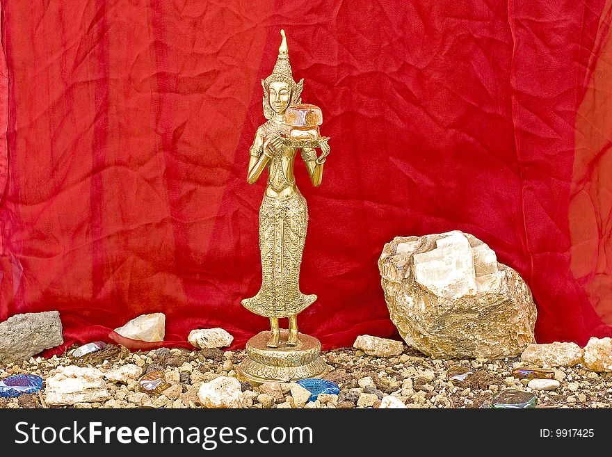 Buddhist statue and minerals colored