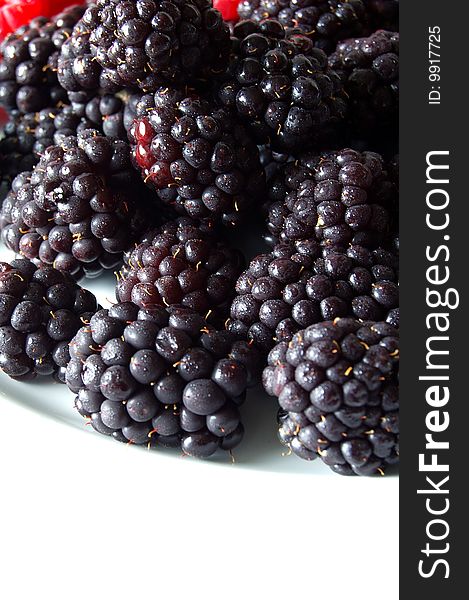Blackberries on a white plate.