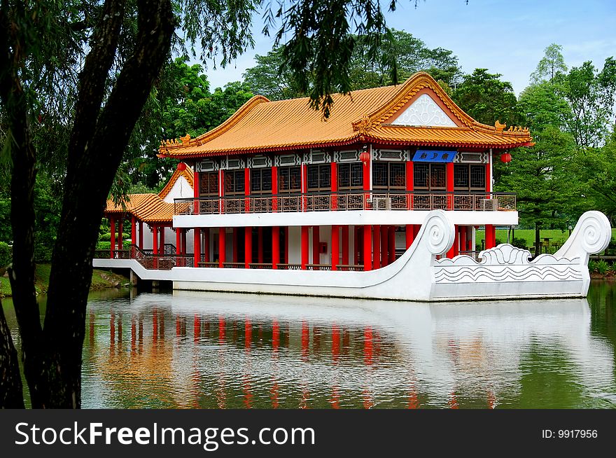 A beautiful stone boat with teahouse pavilion built above its deck sits on the lagoon at the Jurong Chinese Garden - Xu Lei Photo / Lee Snider Photo Images. A beautiful stone boat with teahouse pavilion built above its deck sits on the lagoon at the Jurong Chinese Garden - Xu Lei Photo / Lee Snider Photo Images.