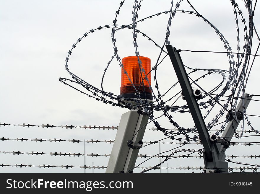 The barbed wire with clouds and light